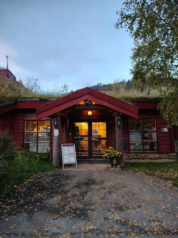 a red building with a sign in front of it at Nordnes Kro og Camping in Rokland