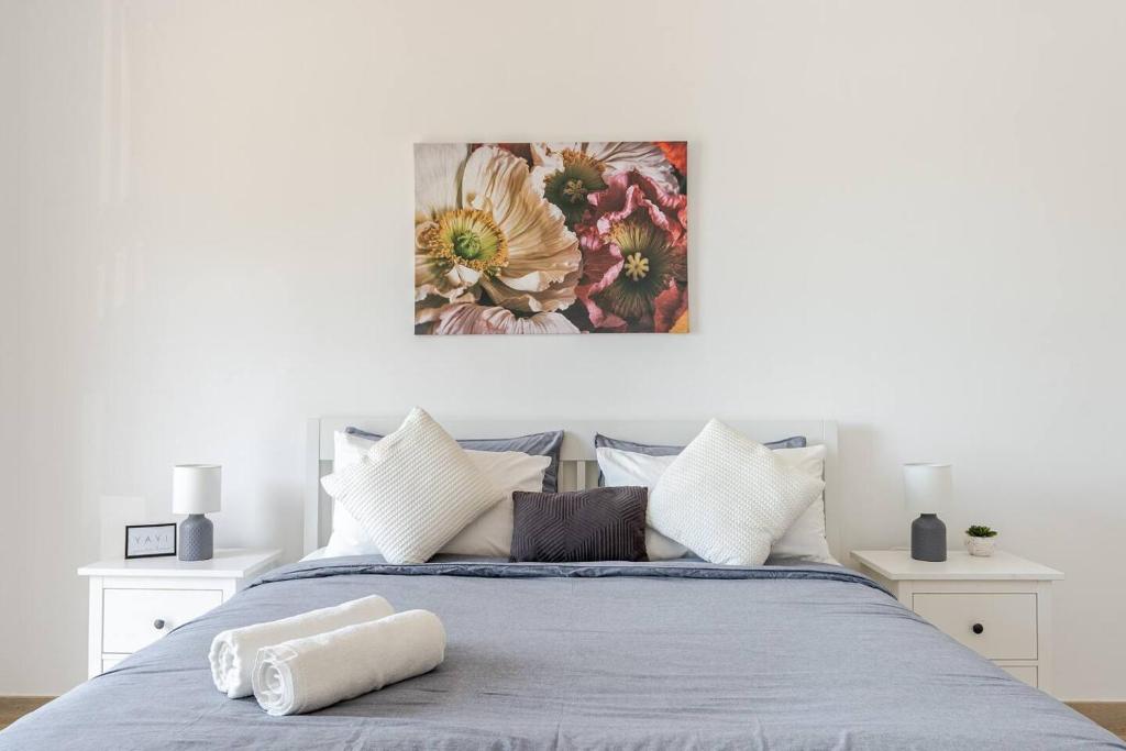 a bedroom with a bed with a painting on the wall at F1 - A Place to Stay 1BR Waters Edge Yas Island - Theme Parks in Abu Dhabi