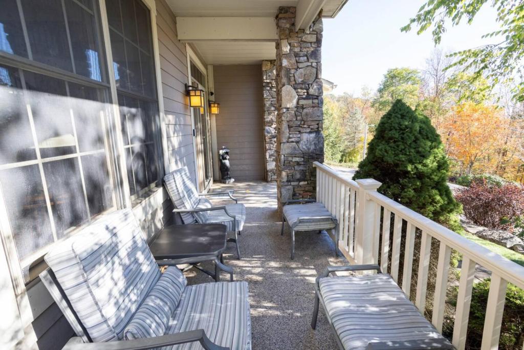 a porch with benches on a house at Summit Retreat Seven Springs in Champion