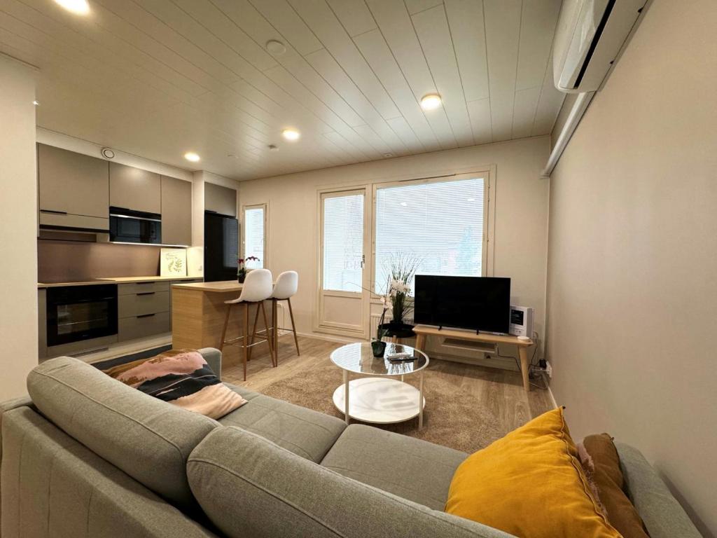 a living room with a couch and a table at Convenient Apartment for 2 in Kotka