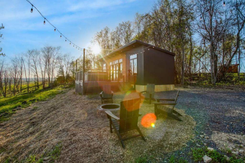 a tiny house in the middle of a field at Alpine Abode - Hot Tub, Nature in Brookville
