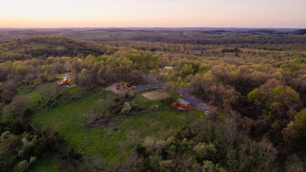 an aerial view of a house on a field with trees at Sanctuary Summit - Hot Tub in Brookville