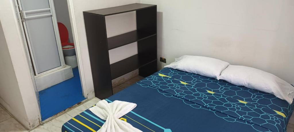 a small bedroom with a bed and a window at Nuestra Tierra Hotel Boutique in Mocoa