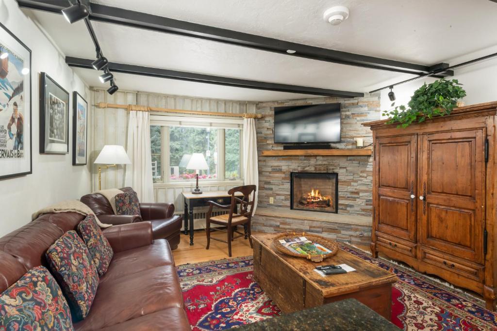 a living room with a couch and a fireplace at Christiania Condominiums- CoralTree Residence Collection in Vail