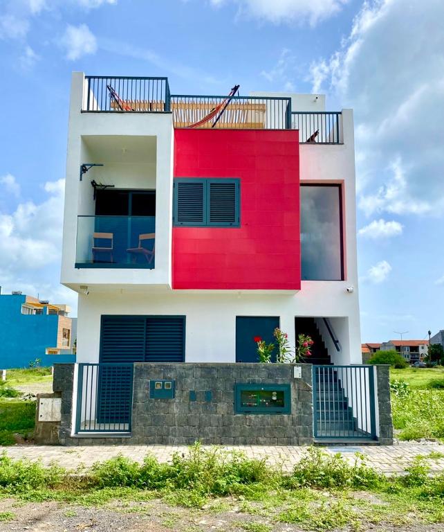 una casa bianca e rossa con un balcone nero di Casa Uta a Tarrafal