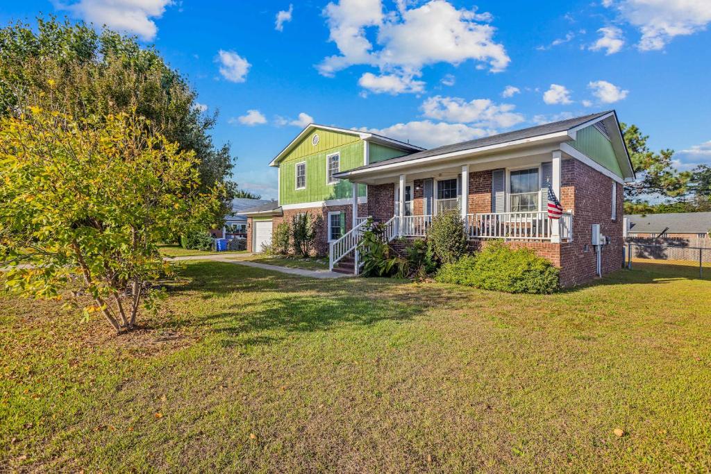 a house with a green and yellow house at Blue Sky Landing in Fayetteville