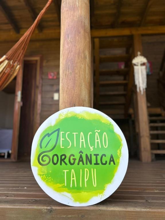 a green and white plate on a wooden table at Estação Orgânica Taipu in Marau