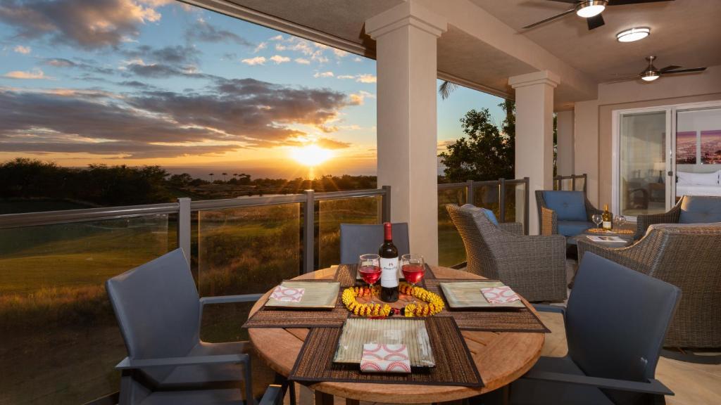 a patio with a table and chairs and the sunset at ❤PiH❤ Sun Ray RetreatOcean Sunsets ViewsOptional Mauna Kea Hotel Privileges in Waimea