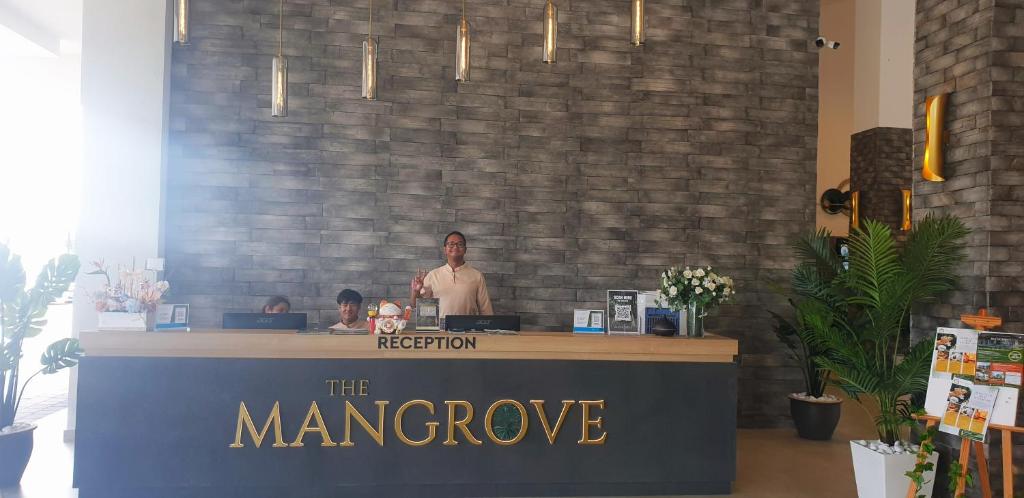 a man is standing behind a counter in a store at The Mangrove at Carey Circles 