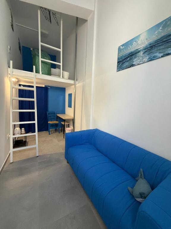 a blue couch in a living room with a bunk bed at BLUE Cabin-Larnaca Centrum in Larnaka