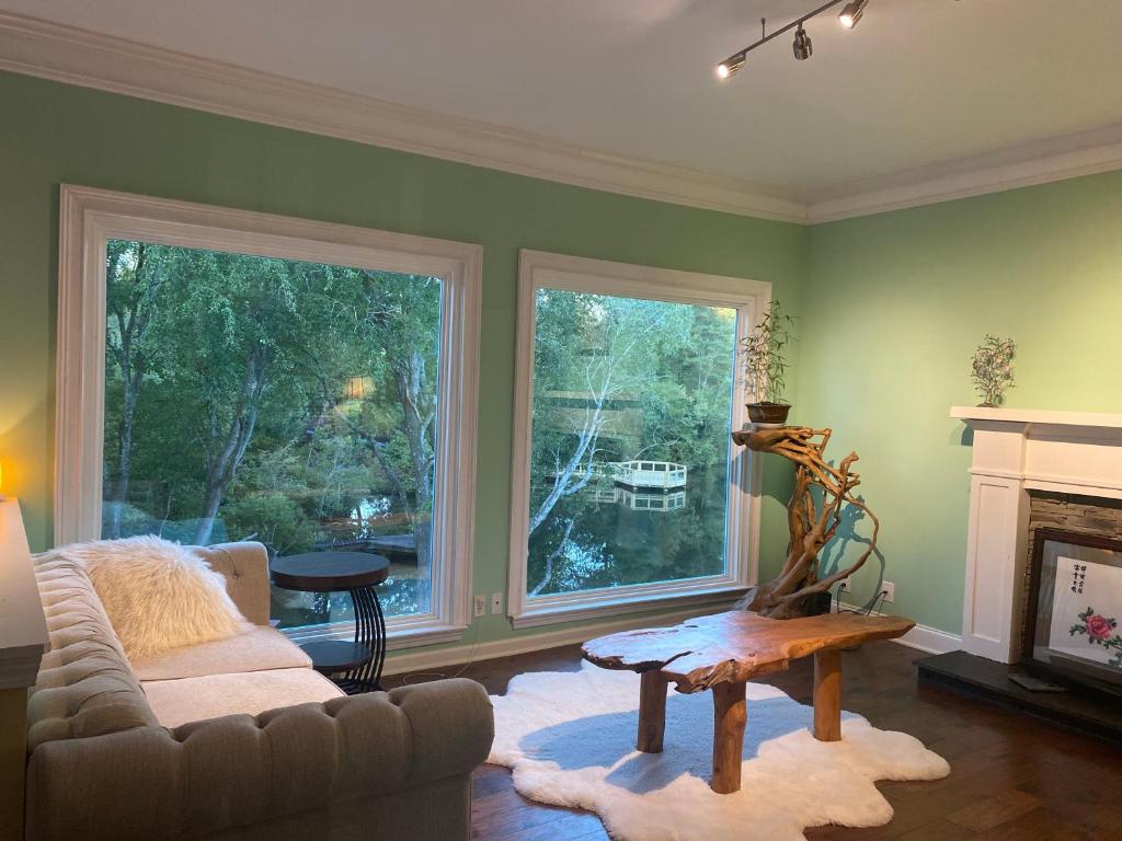 a living room with a couch and a fireplace at Suite in Lakeside house in Alpharetta