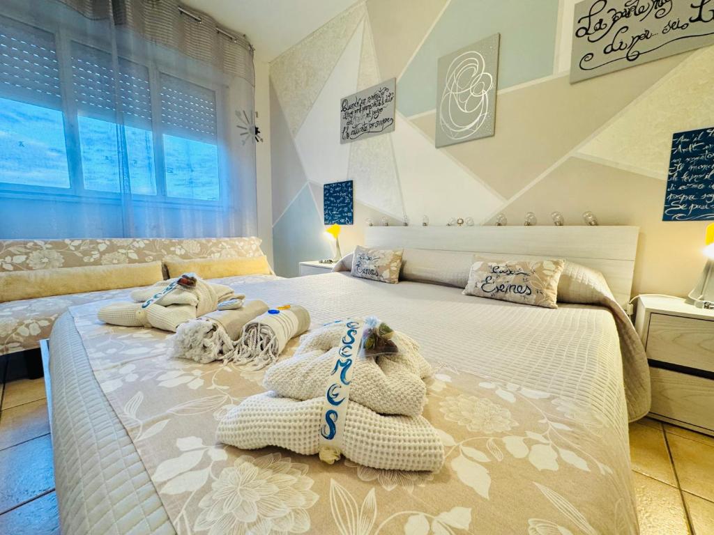 a bedroom with two beds with towels on them at Casa Esemes in Giarre