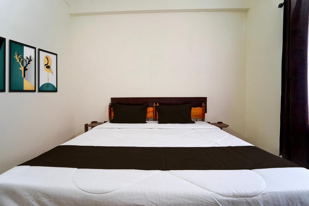 a bedroom with a large white bed in a room at Collection O Govt Engineering College Formerly Anby Plaza in Trivandrum