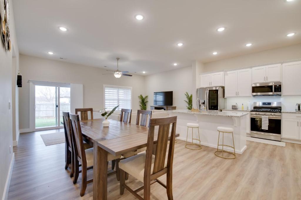 a kitchen and dining room with a wooden table and chairs at Pet-Friendly Ozark Home with Yard and Patio in Ozark