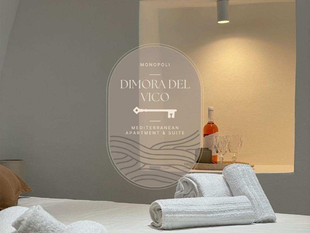 a room with a bed with a sign on the wall at Dimora del Vico - Mediterranean Apartment & Suite in Monopoli