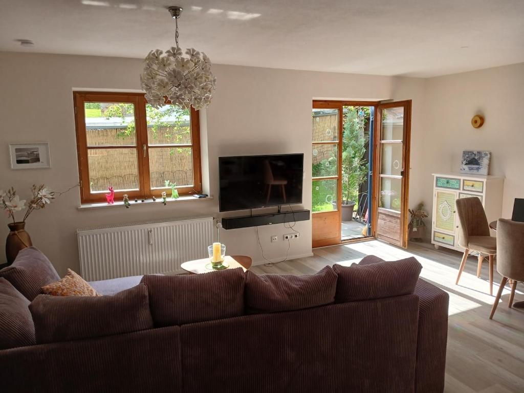 a living room with a couch and a tv at Allgäunest in Oberstdorf