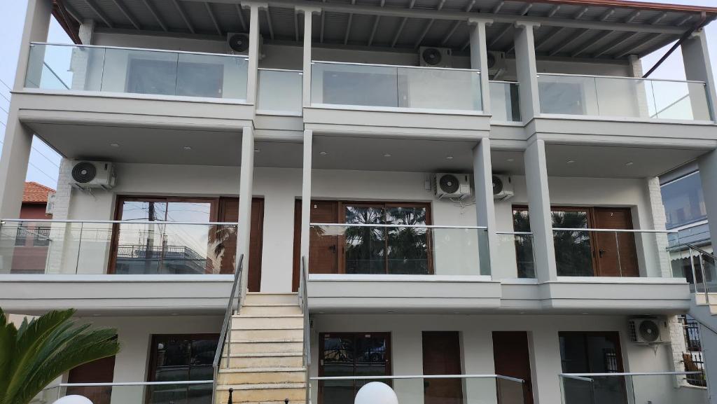 a large white building with glass windows at VILA NIKOLETA in Ierissos