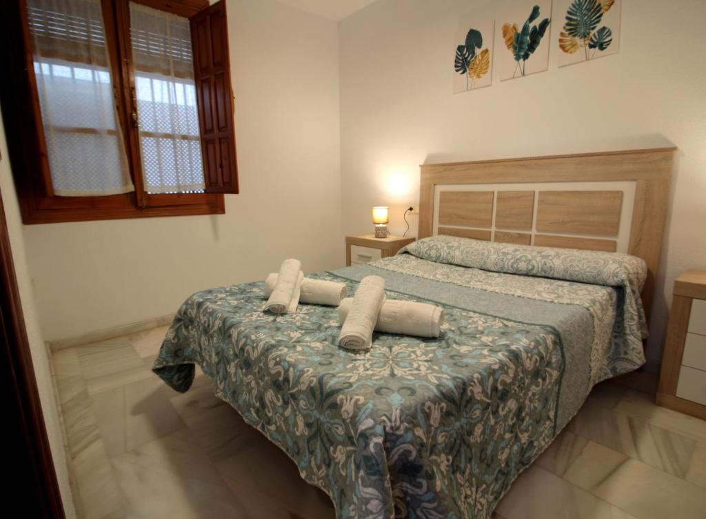 a bedroom with a bed with two pillows on it at El Refugio de la Judería in Córdoba