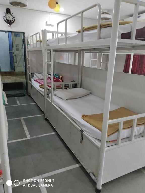 a bedroom with two bunk beds in a room at Backpackers Dormitory in Ernakulam