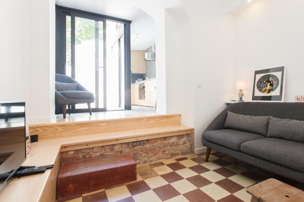 uma sala de estar com um sofá e uma janela em FLH Modern Flat Principe Real em Lisboa