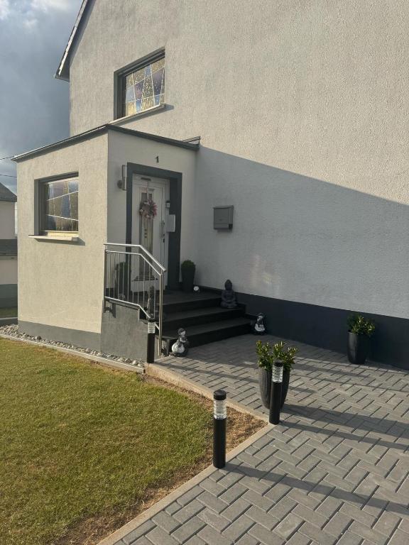 a house with two dogs sitting outside of it at Landliebe Osburg in Osburg