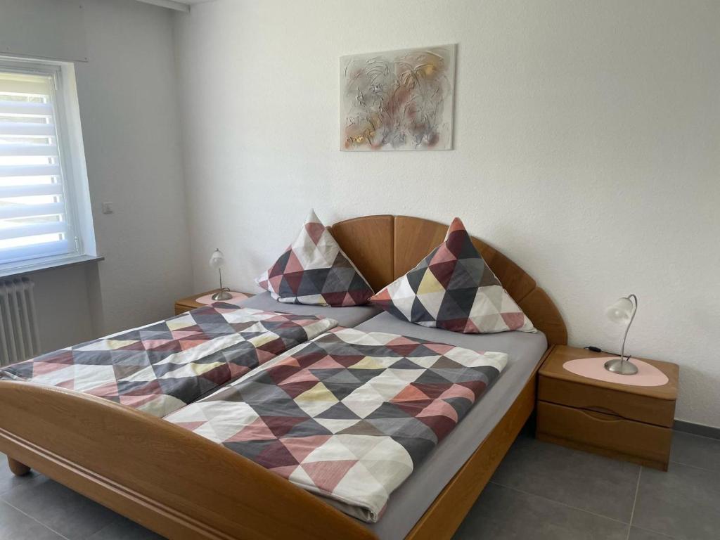 a bedroom with a bed with a checkered blanket at Landliebe Osburg in Osburg