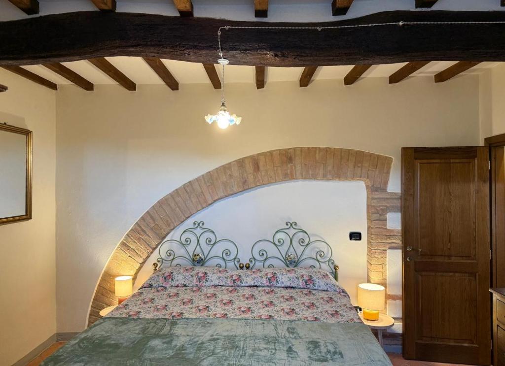 a bedroom with a large bed in a room at Casina Gattoli in Montalcino