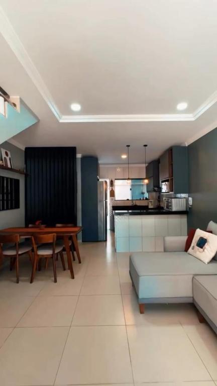 a living room with a couch and a table at Residencial Recanto dos Colibris in Porto Seguro