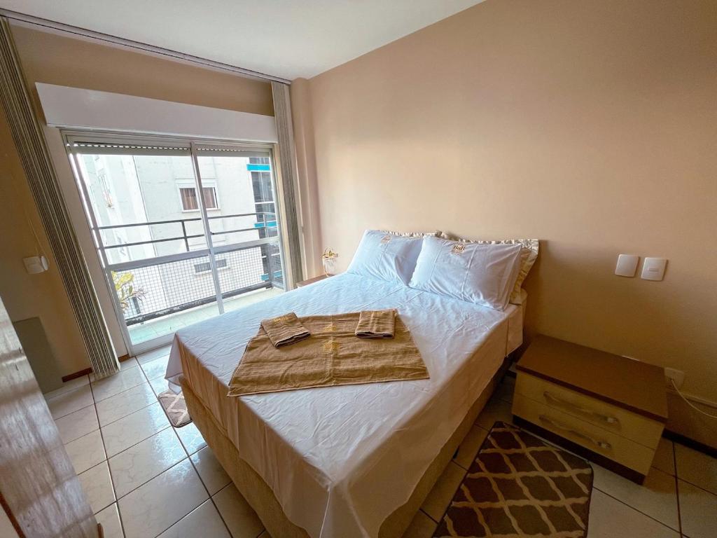 a bedroom with a bed with a towel on it at Rua Capitao Eleuterio, 210 - Centro · SI Belo Apto – Próx. HSVP e Hospital de Clínicas in Passo Fundo