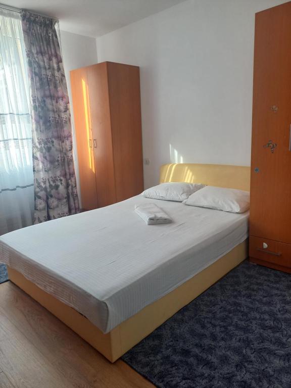 クラヨーヴァにあるPatrick Homeの白いシーツが敷かれた大きなベッドのある寝室