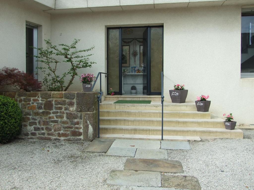 a front door of a house with stairs and flowers at il giardino F Heudier ,E Decourcy ,Tessy sur vire Manche in Tessy-sur-Vire