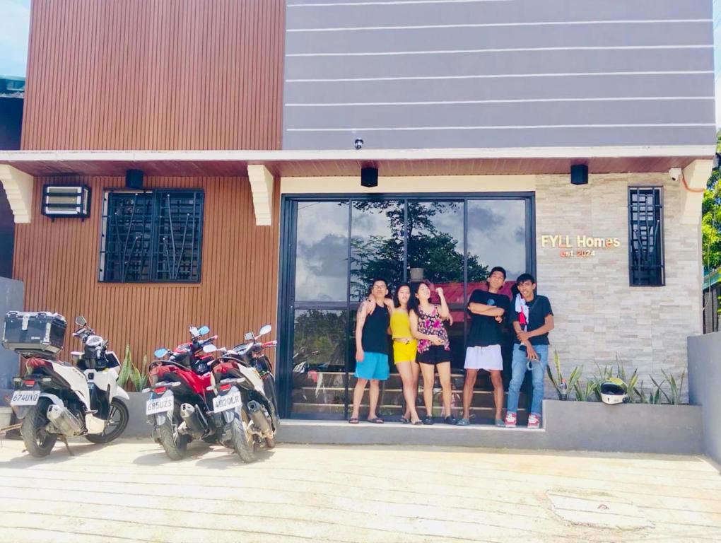 a group of people standing outside of a building at FYLL Homes - Francheska Suite Stylish 1-Bed Apartment with FREE parking in Cavinti Near Hulugan Falls in Cavinti