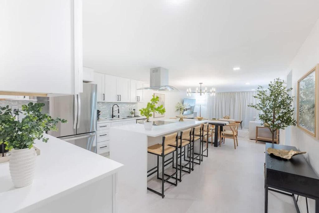 a kitchen with white cabinets and a table and chairs at Magnificent Beach Front Condo - Flagler Ave - 111 in New Smyrna Beach