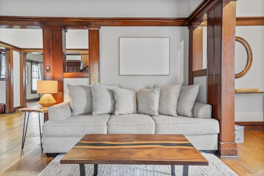 a living room with a couch and a table at Southern Tides- Pool, Fire Pit & Games in Birmingham