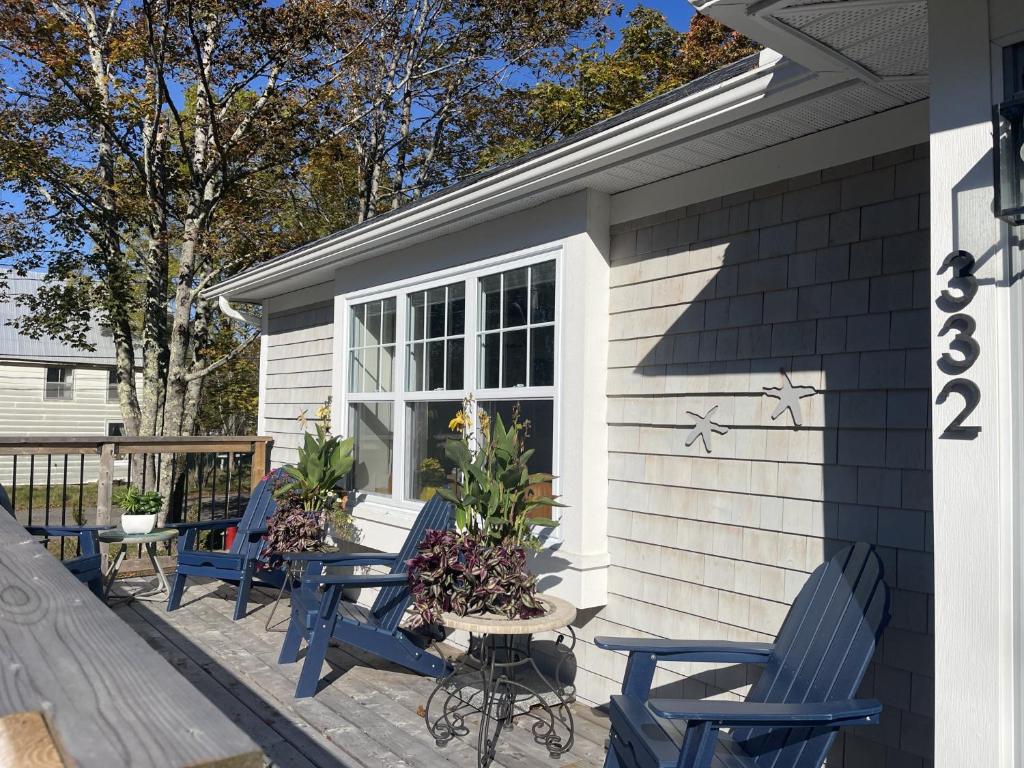 a group of blue chairs sitting on a patio at Seas the Day Bed and Breakfast in Saint Andrews