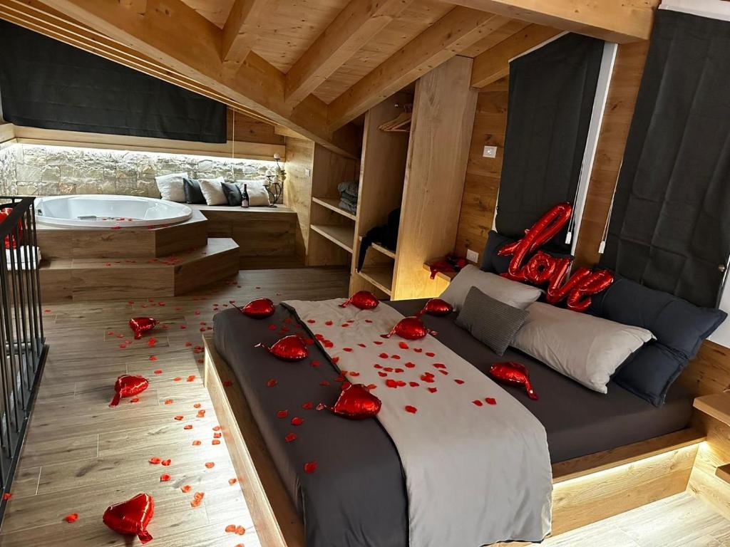 a bedroom with a bed with red roses on the floor at Il giardino dei larici in Selvino