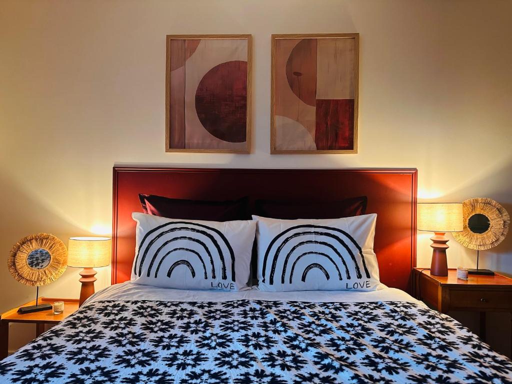 a bedroom with a bed with three pictures on the wall at House with garden 30 minutes to Disneyland and center of Paris in Montreuil