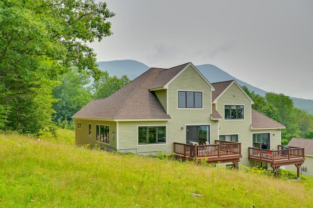 a house on top of a grassy hill at Ski In and Out! Black Mountain Resort Townhome in Jackson