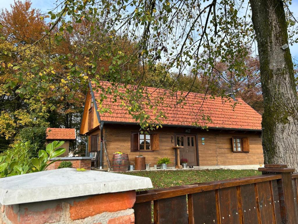 a small house with an orange roof and a fence at Kuća za odmor Josipa in Klanjec