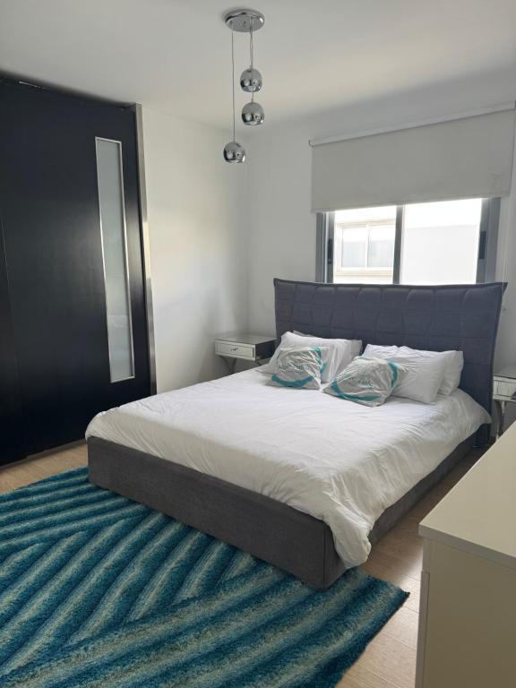 a bed with two pillows on it in a bedroom at Blue Tulip - Strovolos in Kato Lakatamia