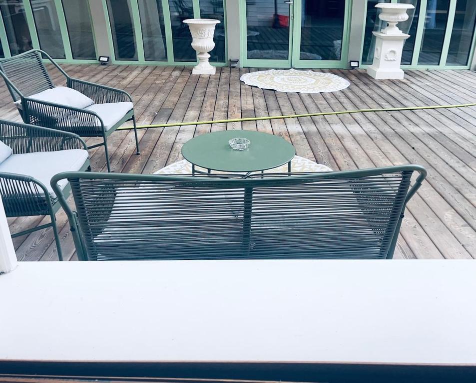 a table and chairs on a wooden deck at cosy studio dans une maison d'hôte in Bourg-en-Bresse