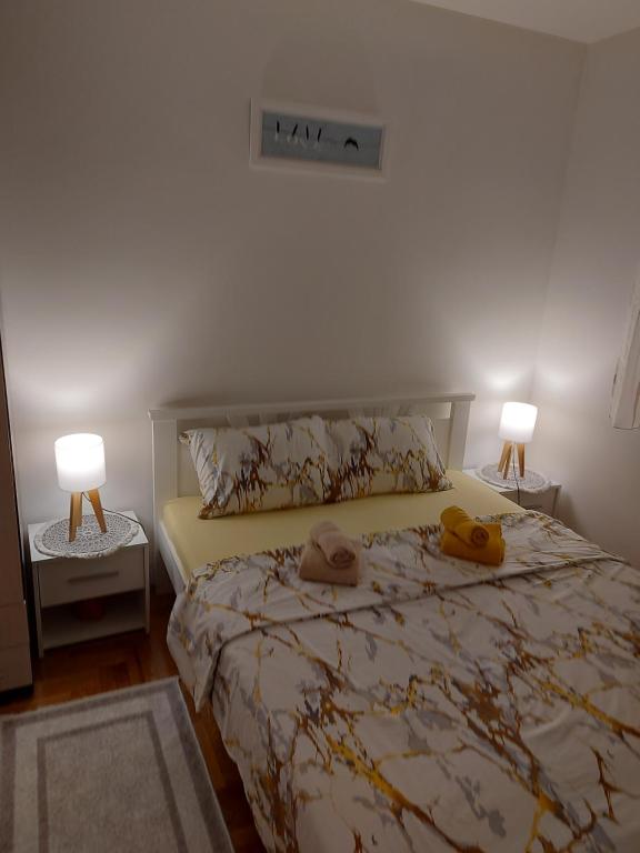 a bedroom with a bed with two towels on it at stancicmilena in Požarevac