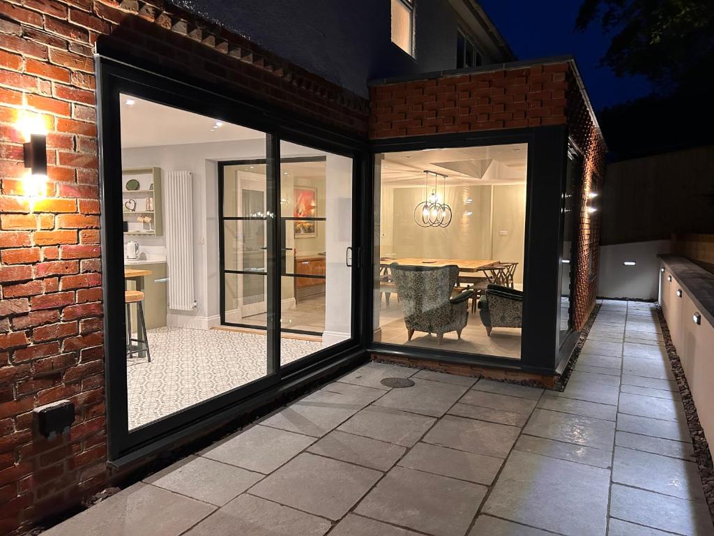 a conservatory with sliding glass doors and a patio at Lynwood House, private 5 bed 4 bath with large drive in Bratton