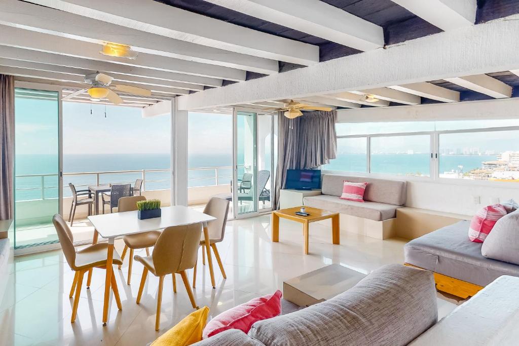 a living room with a view of the ocean at Torre Malibu, PH #902 in Puerto Vallarta