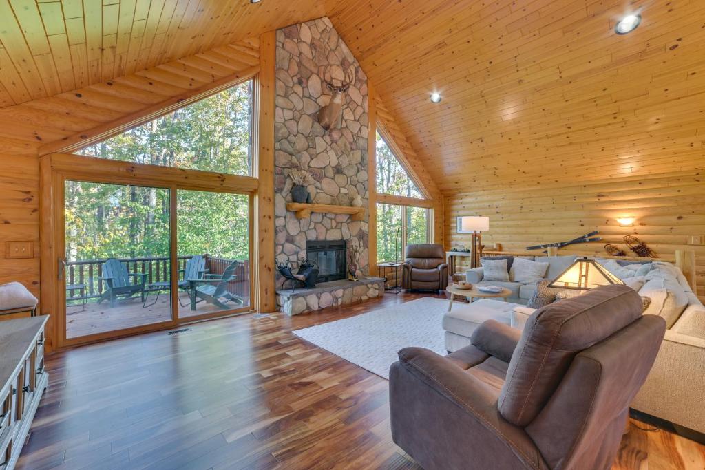 a living room with a fireplace in a log cabin at Luxury Cabin in The Reserve at Boyne Mountain in Boyne Falls