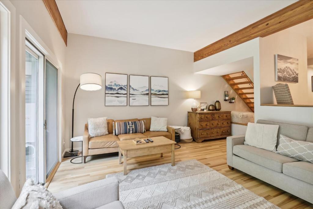 a living room with a couch and a table at Topnotch 329E in Stowe Fork