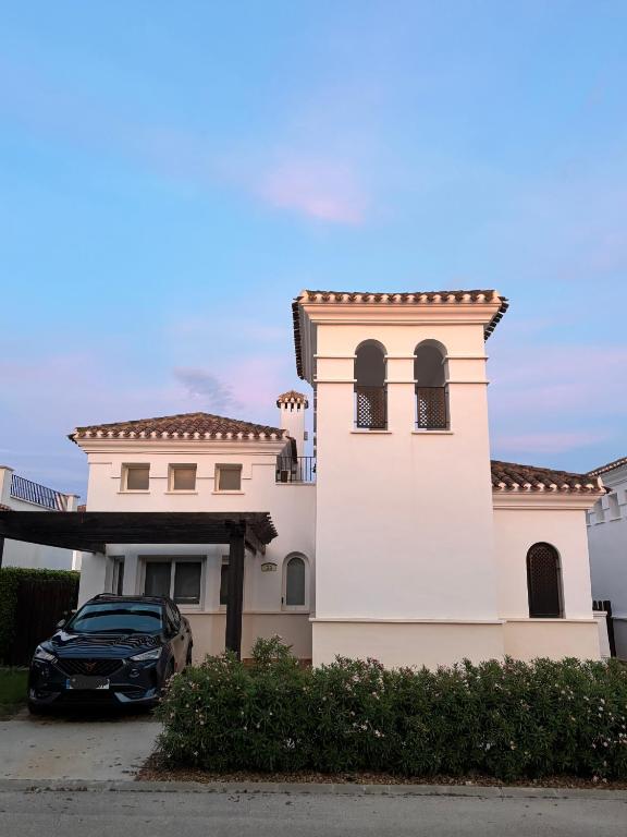 a black car parked in front of a house at Villa Marrajo La Torre Golf Resort in Torre-Pacheco