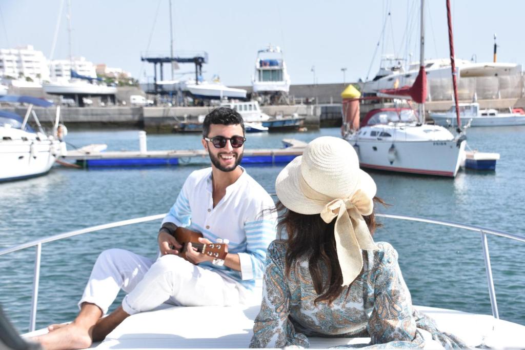 een man en vrouw op een boot in het water bij Luxury boat karamba in San Miguel de Abona