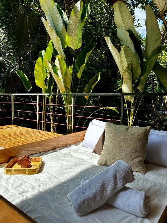 a bed sitting on top of a wooden deck at Exclusive Rainforest Villas in Tapantí