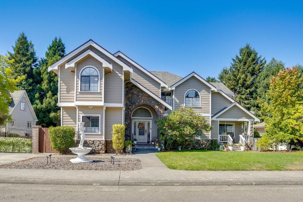 a house with a fountain in the front yard at 3 Mi to Sequoia Park Zoo Spacious Home with Sunroom in Rosewood